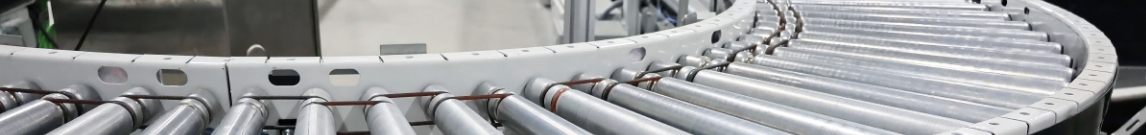 Two-level roller conveyor curve in a warehouse picking area.