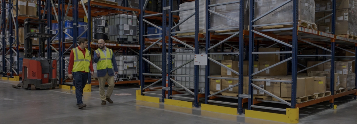 RSC representative consulting with a customer during a warehouse racking assessment.