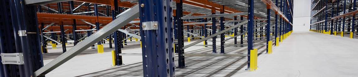 Warehouse aisle highlighting structural column and racking protection.