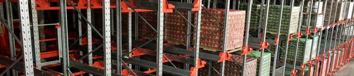 High-density pallet shuttle racking system storing goods on automated carts.