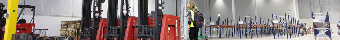 RSC account manager reviewing forklift rental arrivals in newly remodeled warehouse with short racking in the background.
