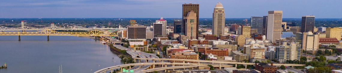 Aerial view of downtown Louisville, KY with skyscraper buildings, Ohio River and bridges.