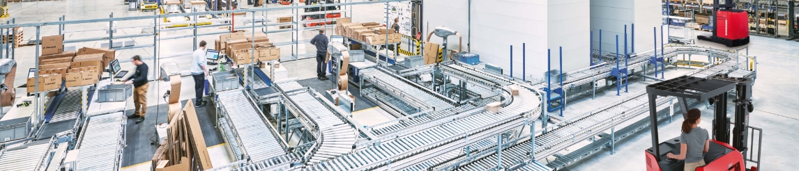 Workers at packing stations sending boxes down a conveyor system that comes from an AS/RS. Raymond forklifts driving by warehouse racking.