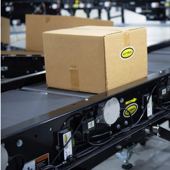 Black Hytrol accumulation conveyors with boxes moving across them.