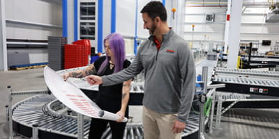 RSC engineers review blueprint for warehouse automation project.