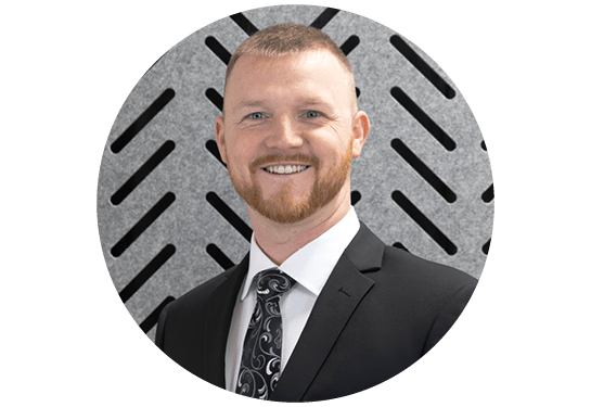 Profile picture of Scott Schloss, RSC Director, National Accounts. In a blue suit with plaid tie on gray patterned background.