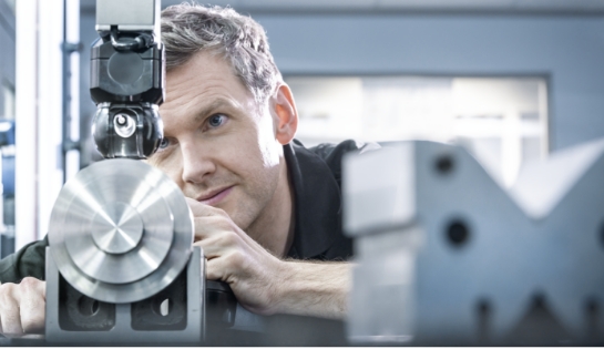 Close up of man looking at a piece of equipment.