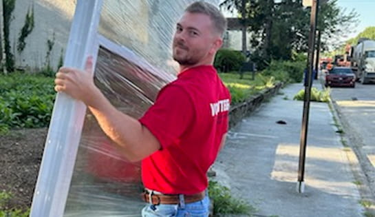 RSC employee carries window for Habitat for Humanity build in Columbus, OH.