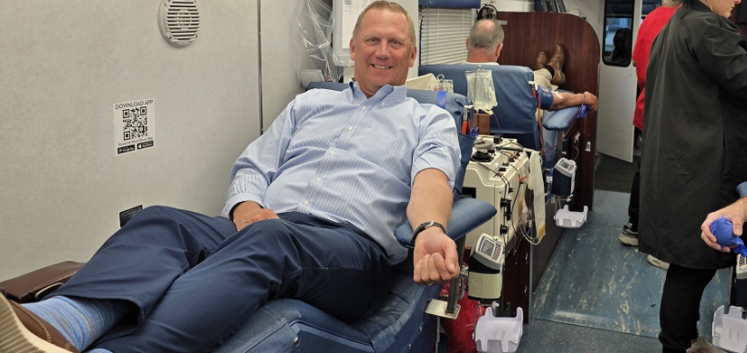 RSC Vice President of Sales & Marketing Neil Williams donates blood in the Hoxworth Mobile Blood Center vehicle during a blood drive.