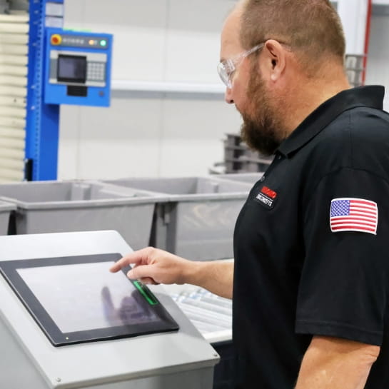 RSC technician reviewing a conveyor control screen.