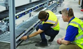 RSCI project manager reviewing conveyor system installation progress with man in safety vest.