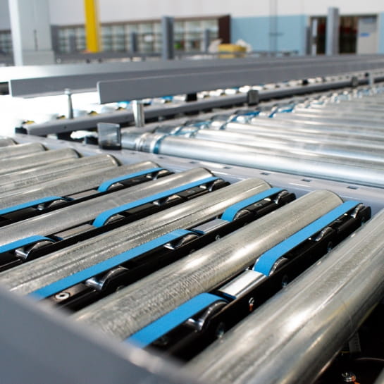 Close up view of a conveyor diverter in the middle of an automated warehouse system.