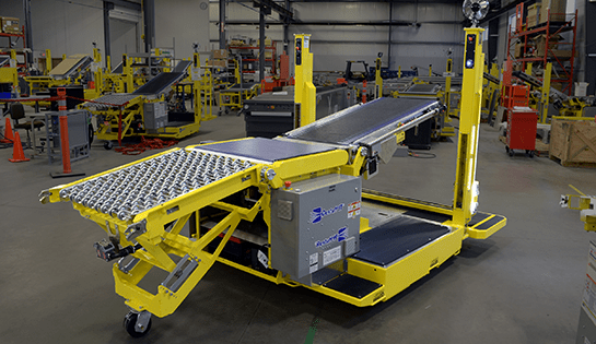 Gray and yellow De-Stuff IT equipment sitting in warehouse.