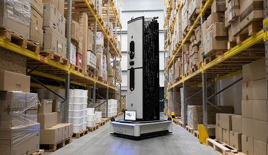 Dexory inventory robot in the middle of warehouse racking aisle.