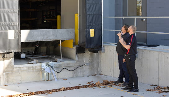 RSC dock specialist assessing a warehouse loading dock with a facility manager.