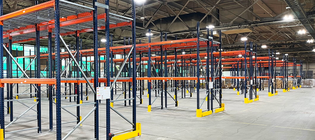 Inside the Blue Ash, OH Eckart Supply distribution center during racking installation. Showing multiple rows of pallet rack in empty warehouse.