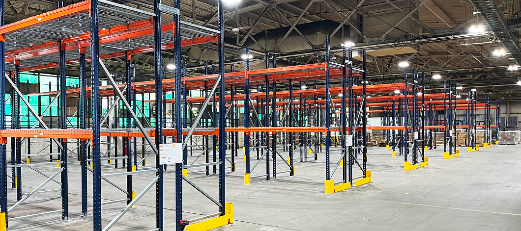 Inside the Blue Ash, OH Eckart Supply distribution center during racking installation. Showing multiple rows of pallet rack in empty warehouse.