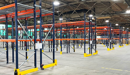 Inside the Blue Ash, OH Eckart Supply distribution center during racking installation. Showing multiple rows of pallet rack in empty warehouse.
