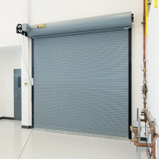 Gray steel rolling door that is fire rated inside a building.