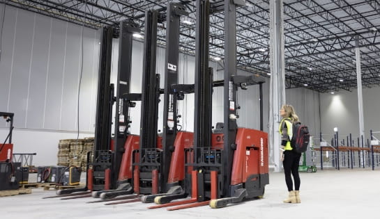 RSC account manager reviewing forklift rental arrivals in newly remodeled warehouse with short racking in the background.