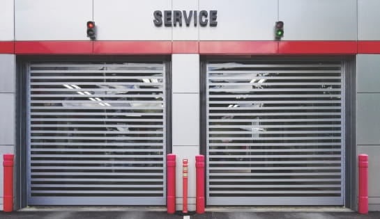 Steel high speed doors in service entrance for a car dealership