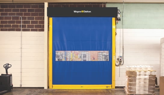 Blue and yellow vinyl high speed door inside a grocery distribution hub.