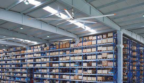 HVLS fan regulating temperatures in warehouse facility with racking.