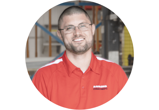 RSC Technical Trainer Mason Bell smiling at the camera in RSC red polo with warehouse in background.