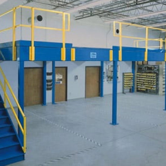 Blue Mezzanine with yellow railings above warehouse office doors.