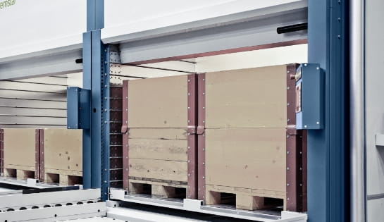 Two pallets loaded inside a large automated storage and retrieval system.