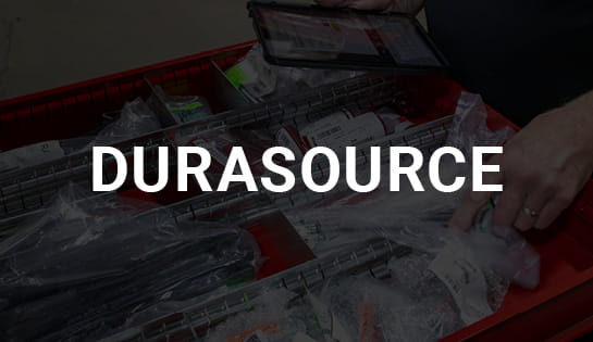 Worker pulling DureSource parts from drawer inside a warehouse facility for mixed brand fleets.