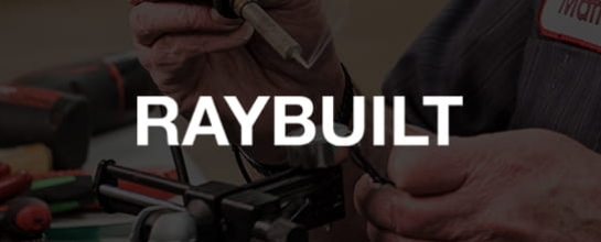RayBuilt. Hands putting together a motor in the background.