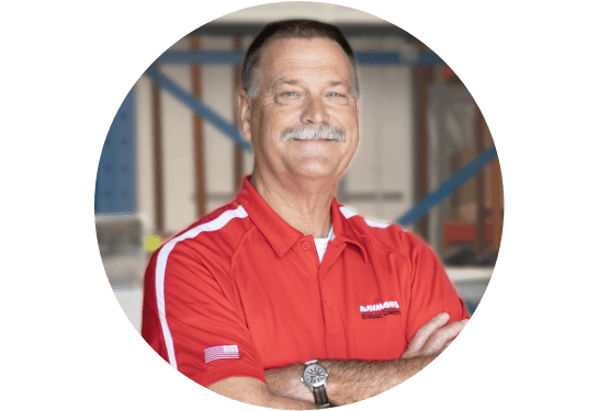 RSC Corporate Training Manager Ron Otto smiling at the camera in RSC red polo with warehouse in background.