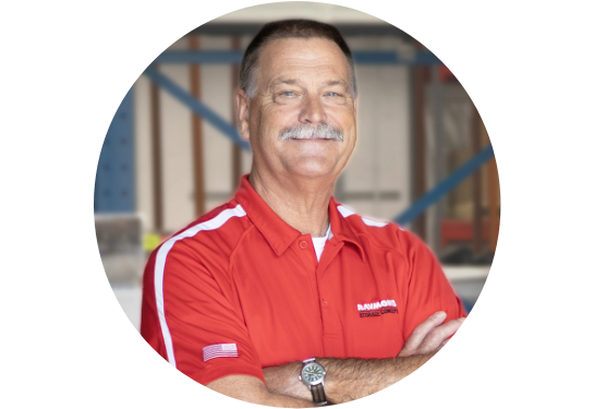 RSC Corporate Training Manager Ron Otto smiling at the camera in RSC red polo with warehouse in background.