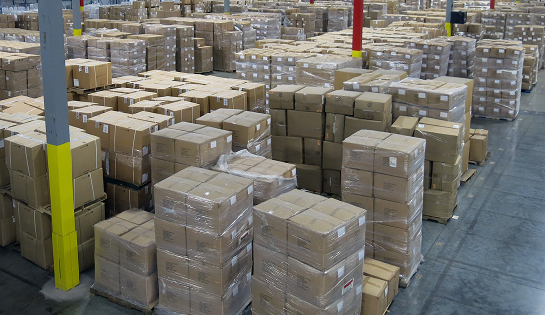 A before view of stacked pallets on the storage floor at the Standard Textile warehouse.