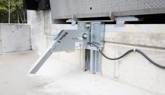 Close up of a vehicle restraint in a dock pit.