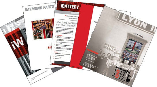 Several Raymond product brochures fanned out.